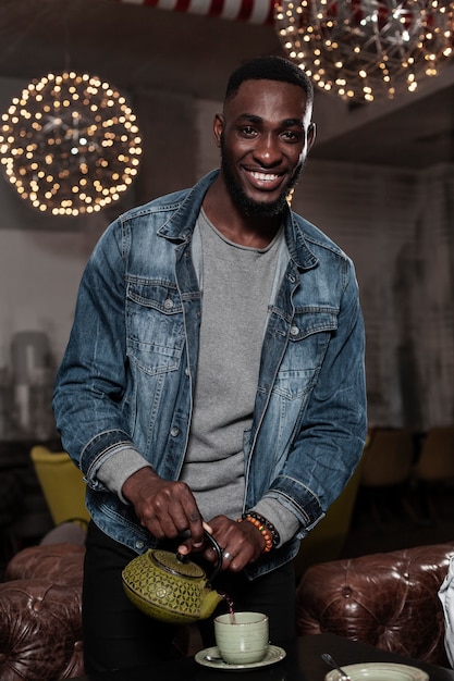 Free photo handsome man pouring tea front view