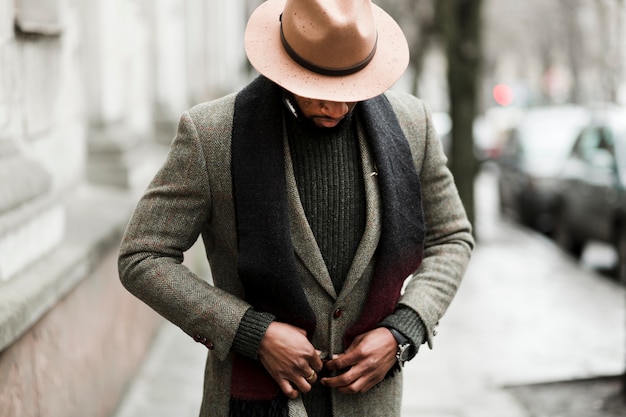 Handsome man putting his jacket on