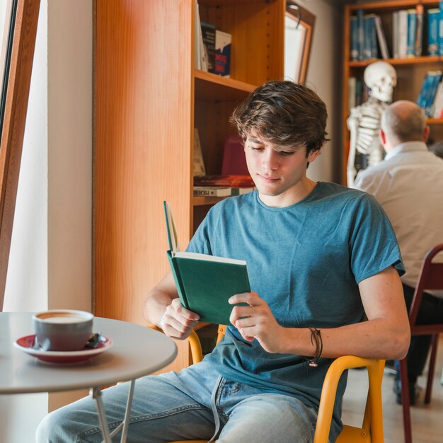 Handsome man reading book