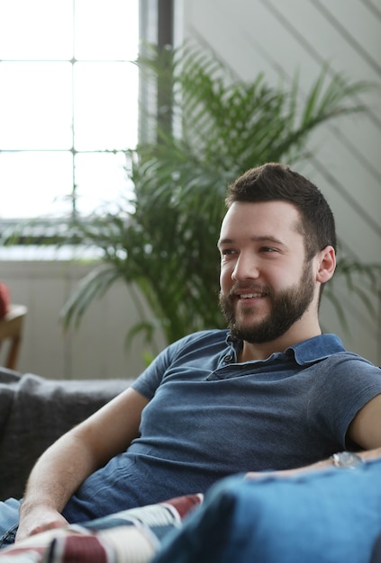 Free photo handsome man relaxing in the coach