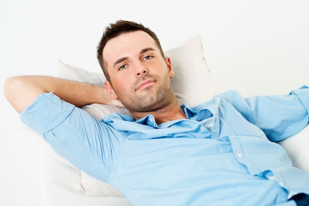 Free photo handsome man relaxing with hand behind head