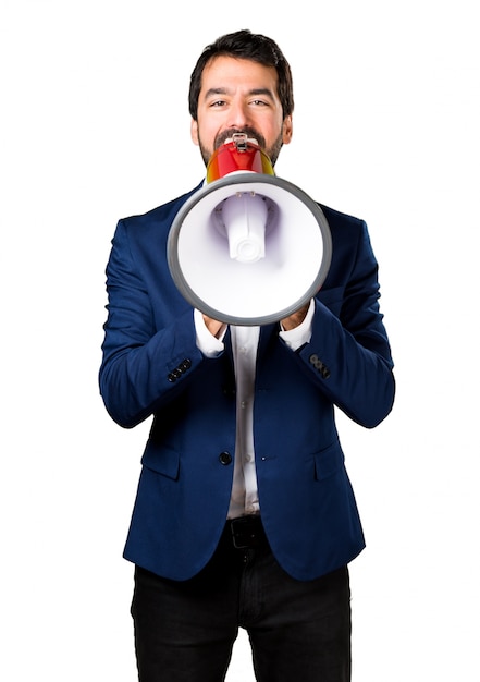 Handsome man shouting by megaphone