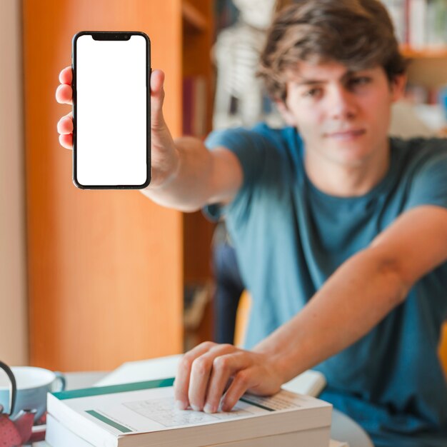 Handsome man showing mobile phone