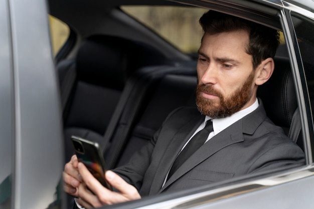 Handsome man sitting in the back of a cab