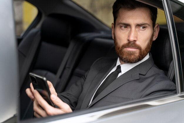 Handsome man sitting in the back of a cab