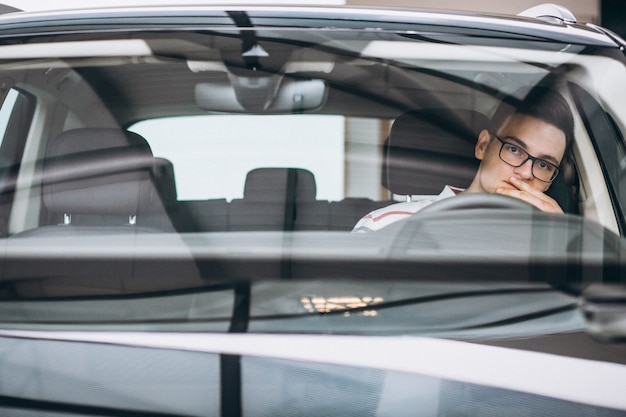 Handsome man sitting in car