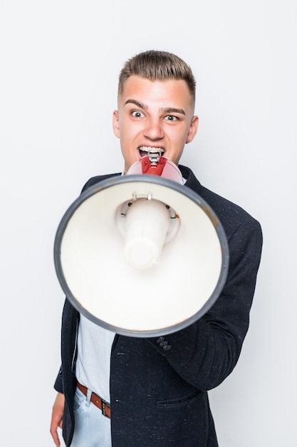 Handsome man speak in loudspeaker dressed up in dark jacket isolated on white