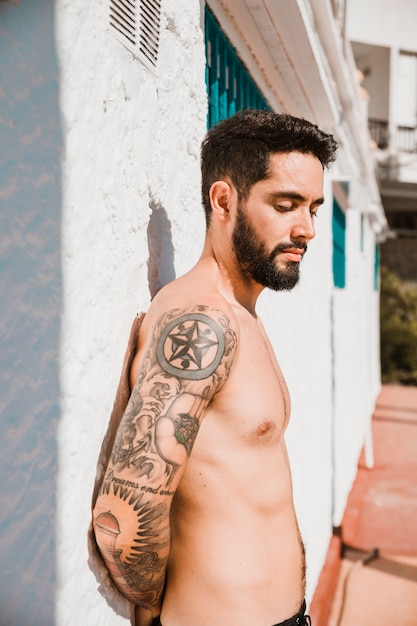 Handsome man standing near building on resort