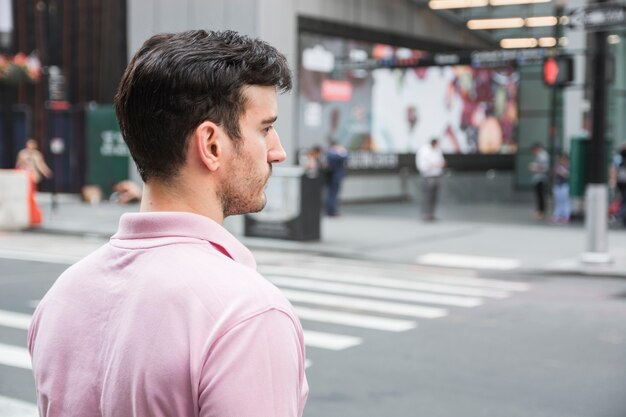 Handsome man standing near road