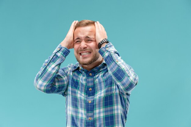 Handsome man in stress isolated on blue