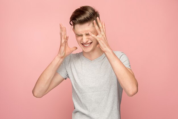 Handsome man in stress isolated on pink