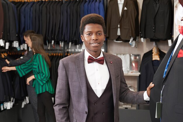 Handsome man in suit posing in boutique.