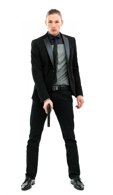 Handsome man in a suit with gun