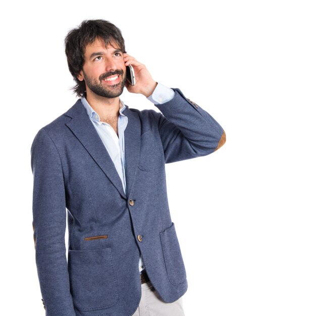 Handsome man talking to mobile over white background