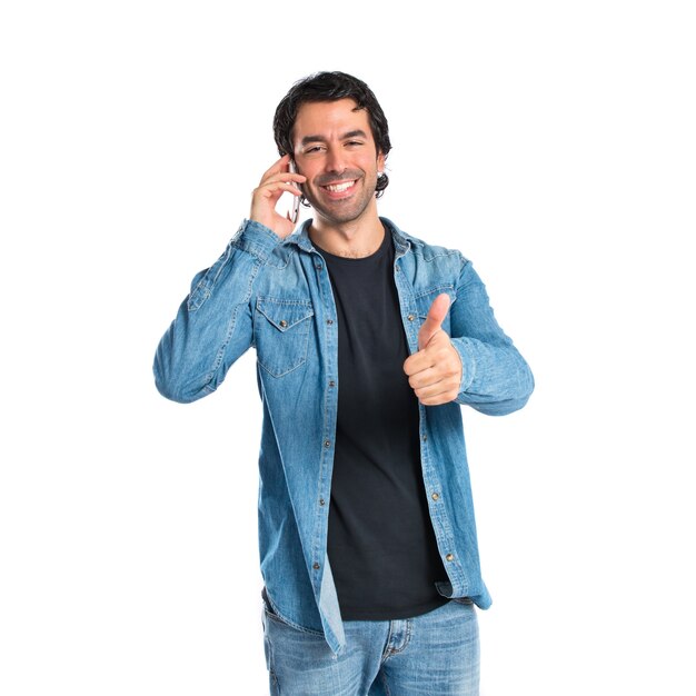 Handsome man talking to mobile over white background