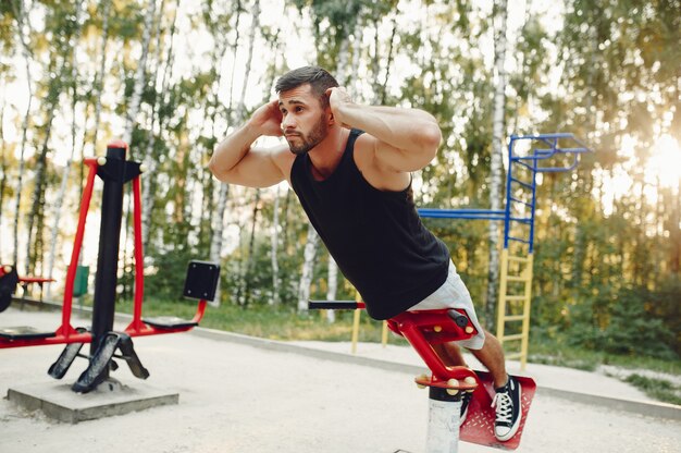 Handsome man training in a summer park