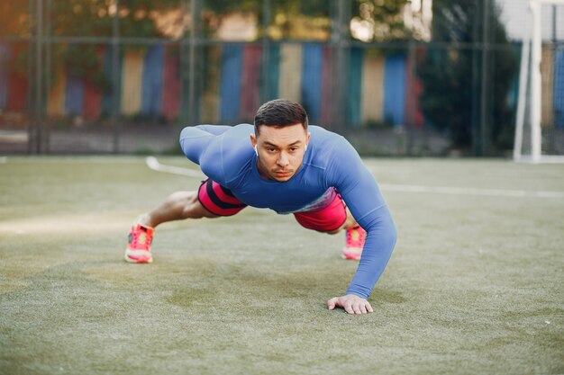 Handsome man training in a summer park