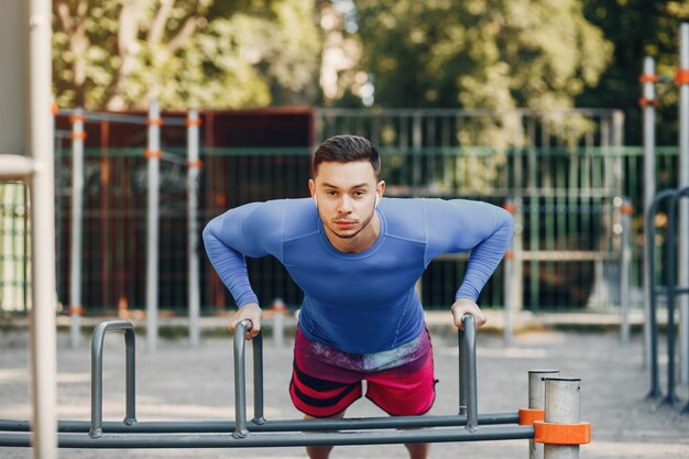 Handsome man training in a summer park