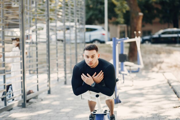 Handsome man training in a summer park