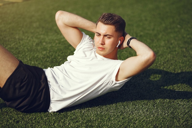 Handsome man training in a summer park