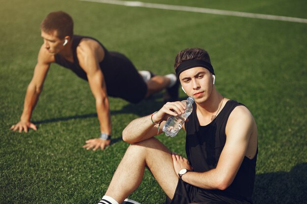 Handsome man training in a summer park