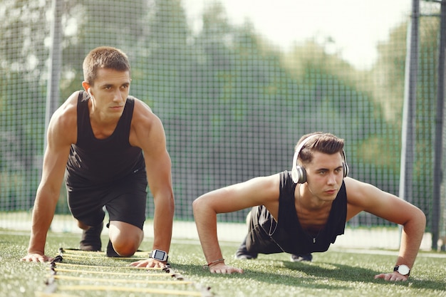 Free photo handsome man training in a summer park