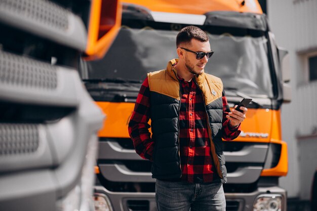 Handsome man truck driver standing by the truck