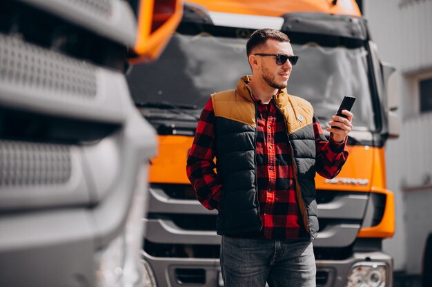 Handsome man truck driver standing by the truck