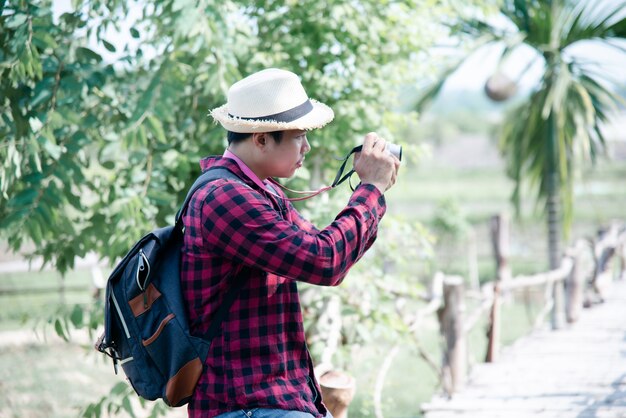 Handsome man using camera in the travel nature