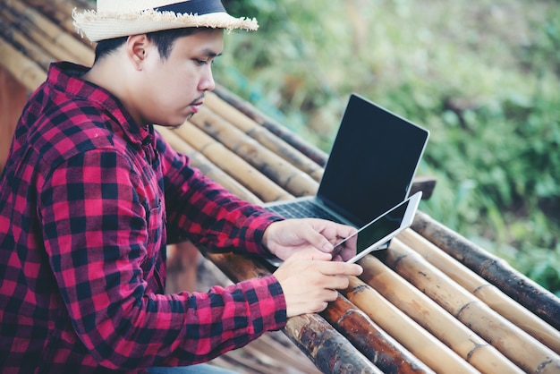 Handsome man using laptop in the travel nature