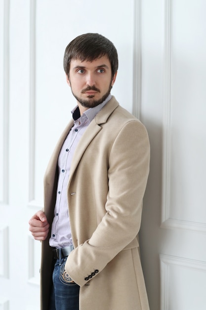 Handsome man wearing beige coat