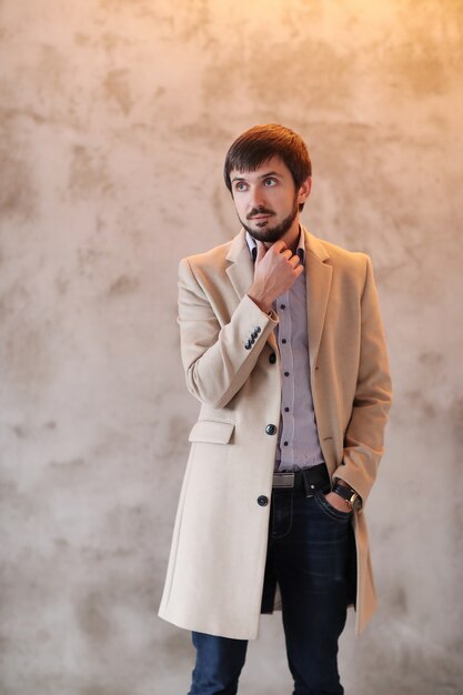 Handsome man wearing beige coat