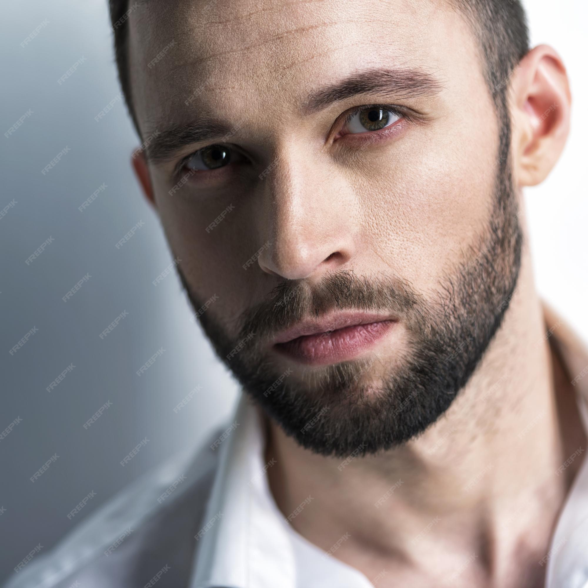Free Photo | Handsome man in white shirt, posing attractive guy with fashion hairstyle. confident man with short beard. adult boy with brown hair. closeup portrait. Free Photo | Handsome man in white shirt, posing attractive guy with fashion hairstyle. confident man with short beard. adult boy with brown hair. closeup portrait.