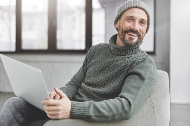 Handsome man with beard and laptop