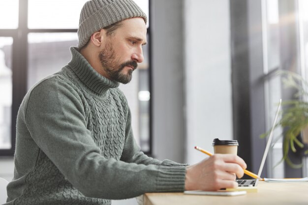 Handsome man with beard and laptop