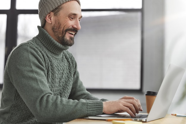 Handsome man with beard and laptop