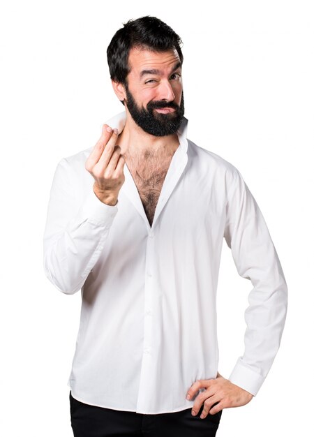 Handsome man with beard making money gesture