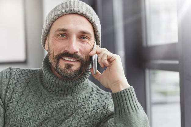 Handsome man with beard and phone
