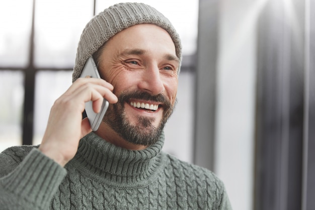 Handsome man with beard and phone