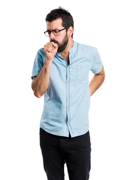 Handsome man with blue glasses coughing a lot