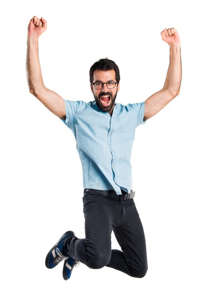 Handsome man with blue glasses jumping