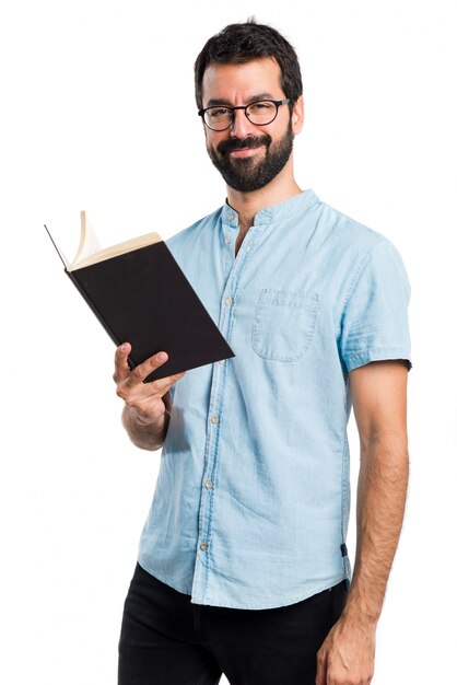 Handsome man with blue glasses reading book