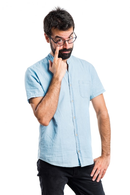 Handsome man with blue glasses showing something