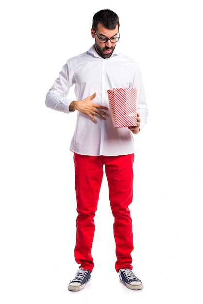 Handsome man with glasses eating popcorns