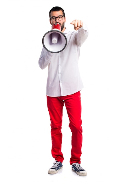 Handsome man with glasses shouting by megaphone