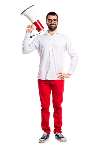 Handsome man with glasses shouting by megaphone