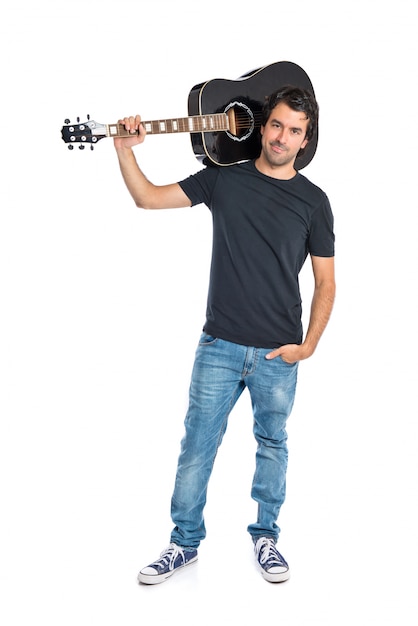 Handsome man with guitar over white background