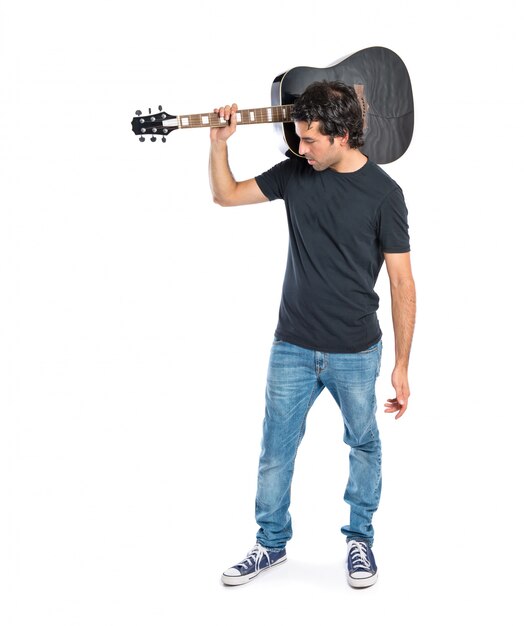 Handsome man with guitar over white background