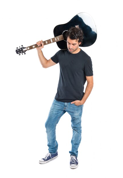 Handsome man with guitar over white background