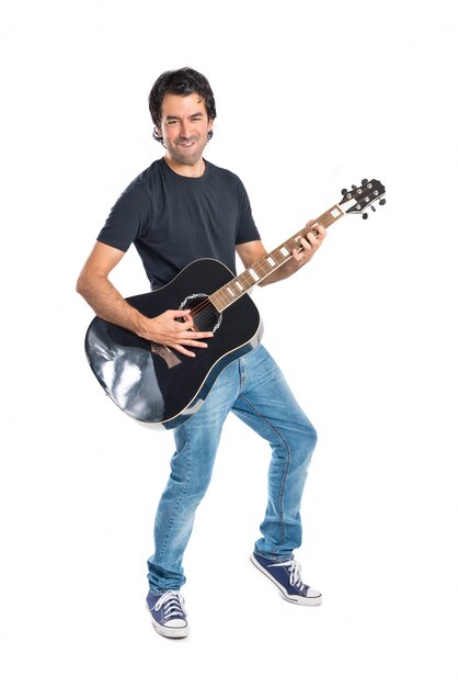 Handsome man with guitar over white background